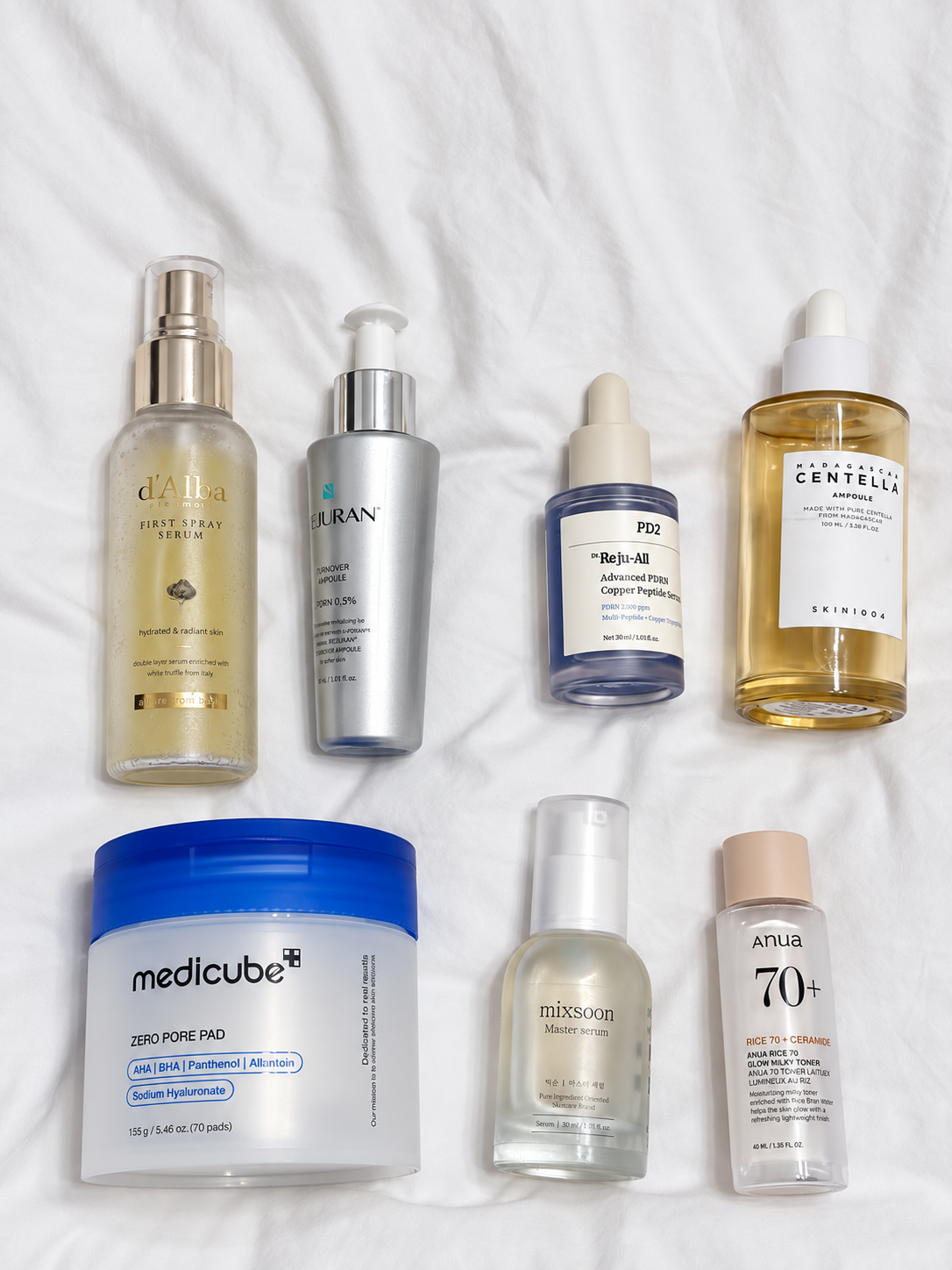 Tracy's daytime toner, serum and essence products arranged on white fabric