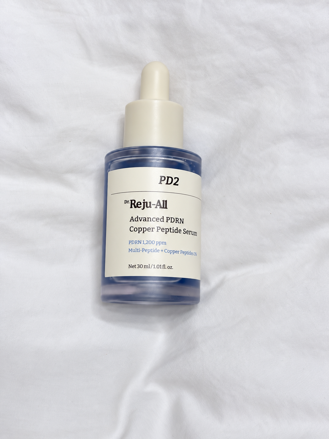Dr. Reju-All Advanced PDRN Copper Peptide Serum on white fabric