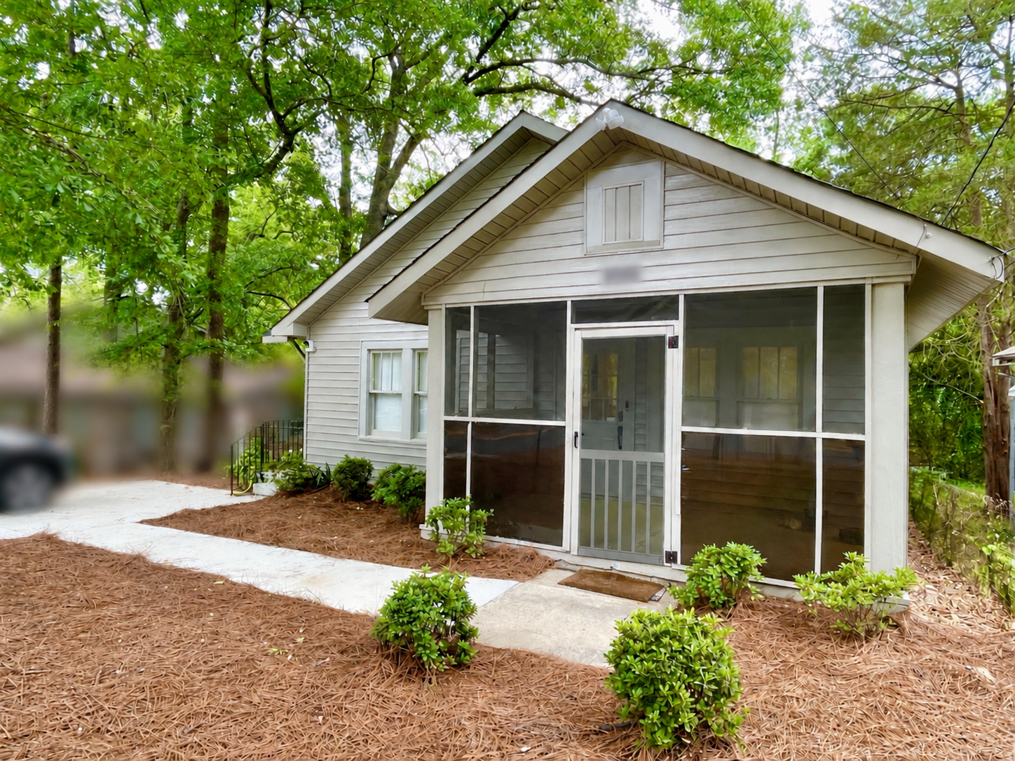 Front exterior of Dragonfly Cottage beneath mature trees