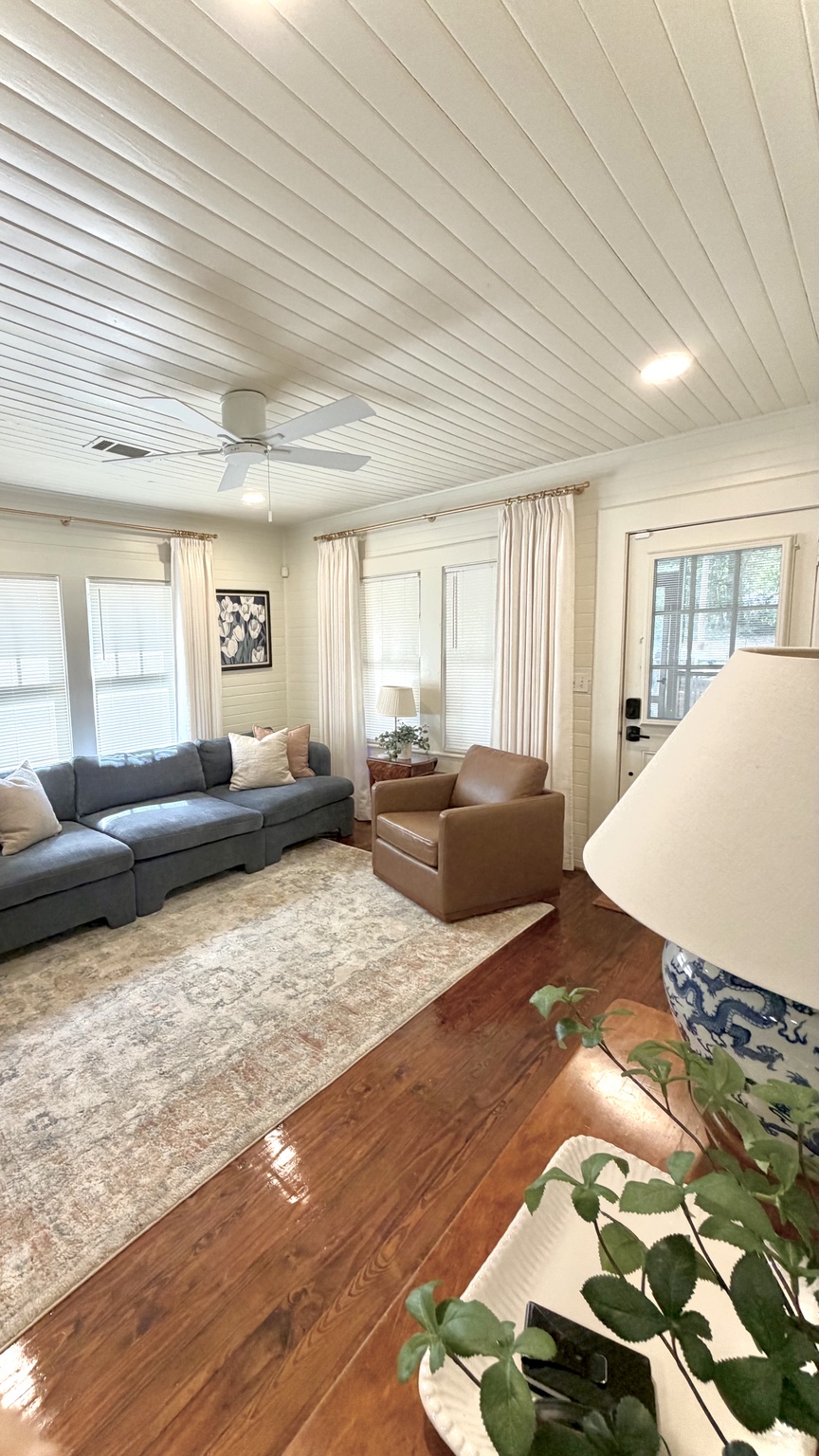 Living room at Dragonfly Cottage with fireplace and blue sofa