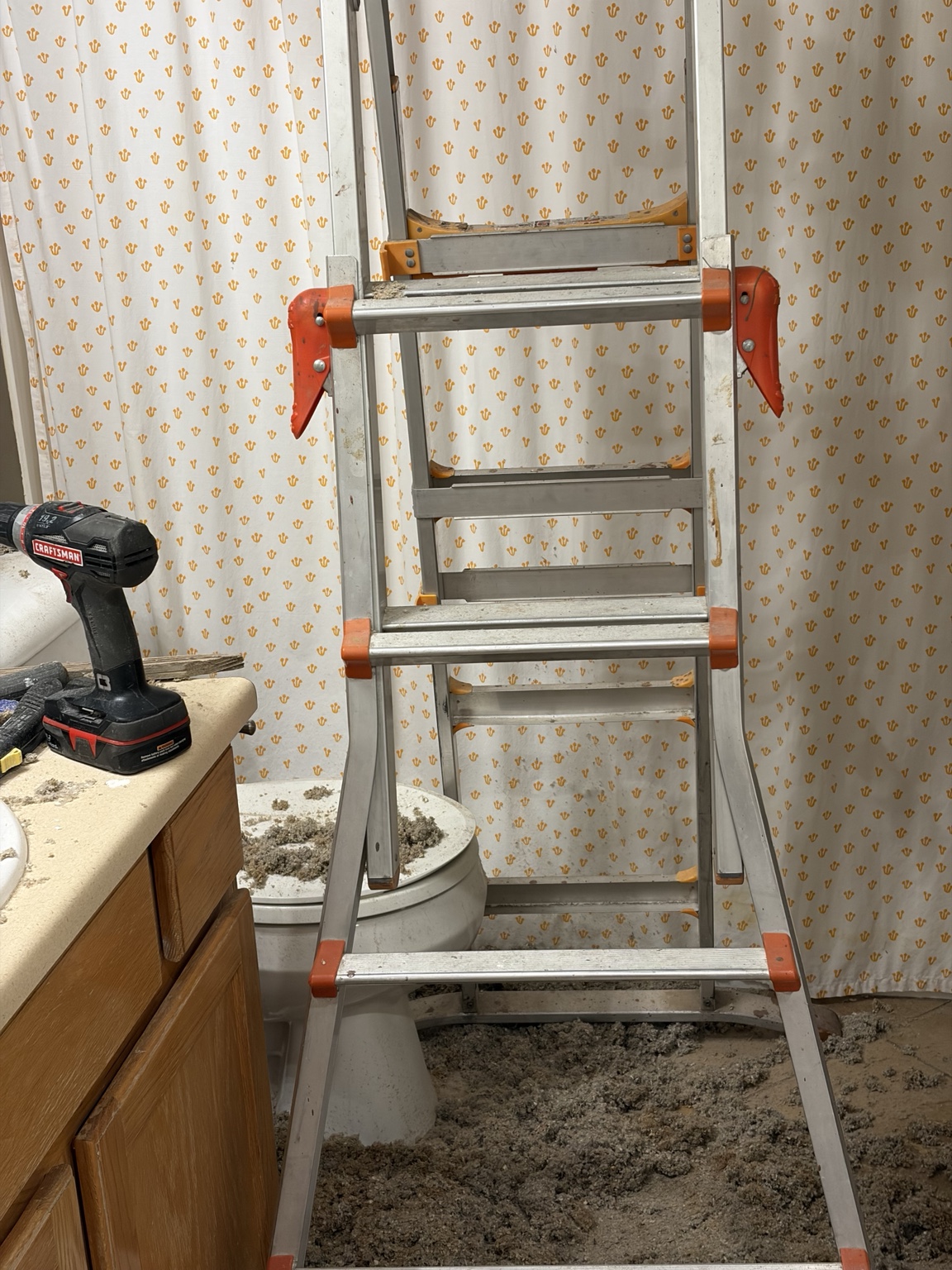 Ladder and insulation debris during bathroom fan installation