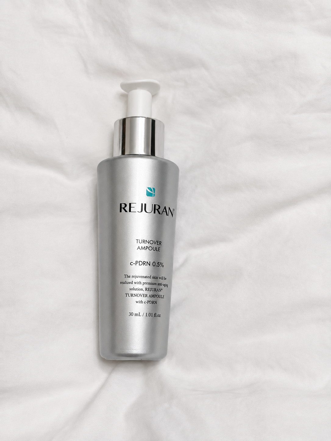 Rejuran Turnover Ampoule on white fabric